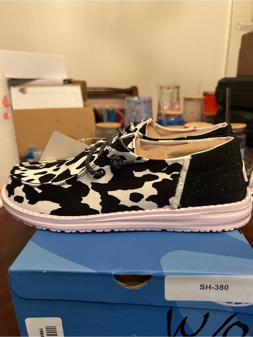 Hey Dude Cow-Print Slip-On Sneakers in Black & White with Pink Sole